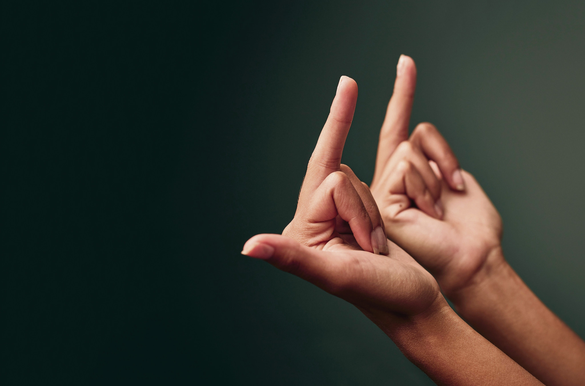 2PRBDAJ Thats what I think of that. Studio shot of an unrecognisable woman showing her middle finger against a green background.