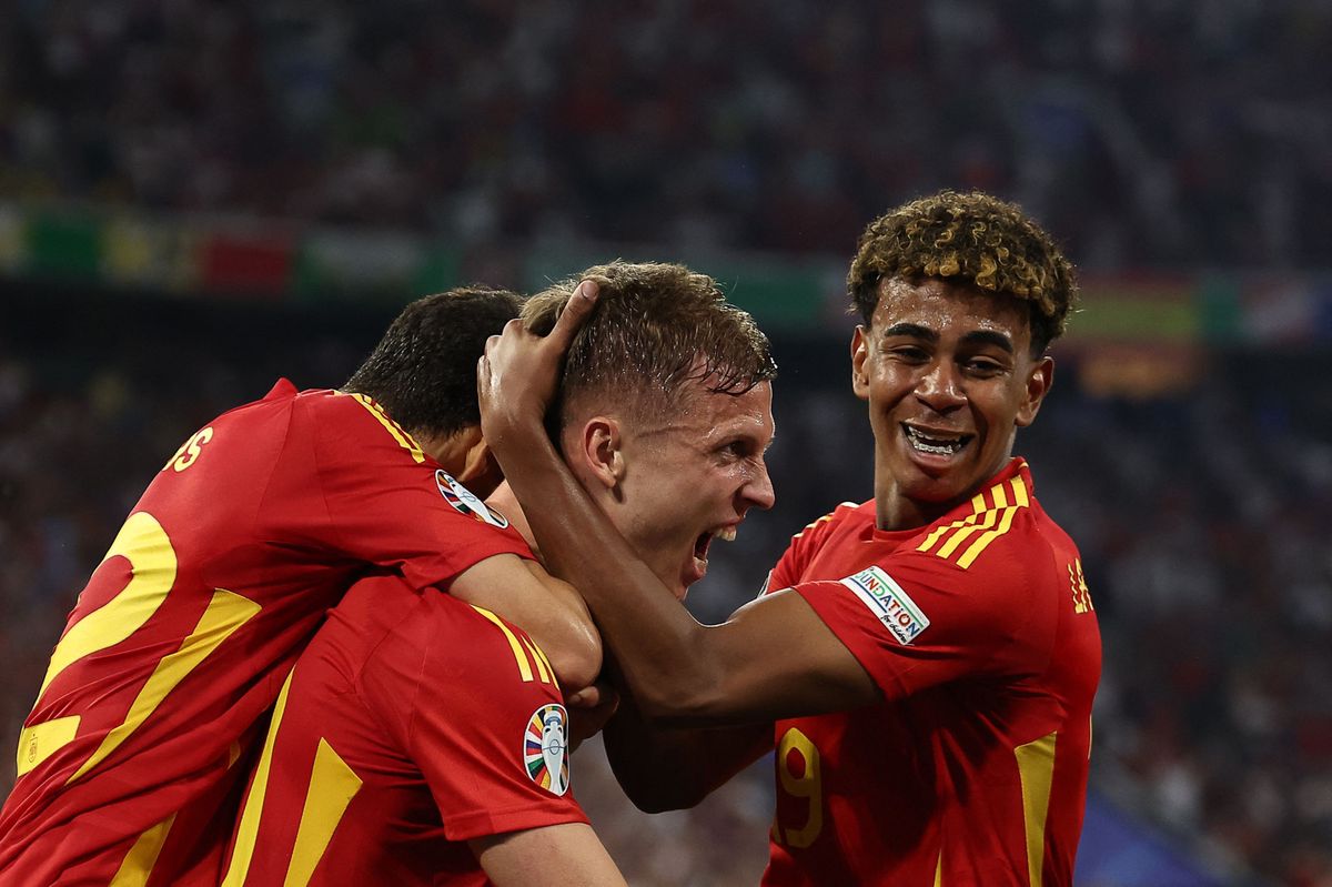 TOPSHOT - Spain's forward #10 Daniel Olmo (C) celebrates with Spain's forward #19 Lamine Yamal France's own goal and Spain's second goal following his kick during the UEFA Euro 2024 semi-final football match between Spain and France at the Munich Football Arena in Munich on July 9, 2024. (Photo by FRANCK FIFE / AFP)