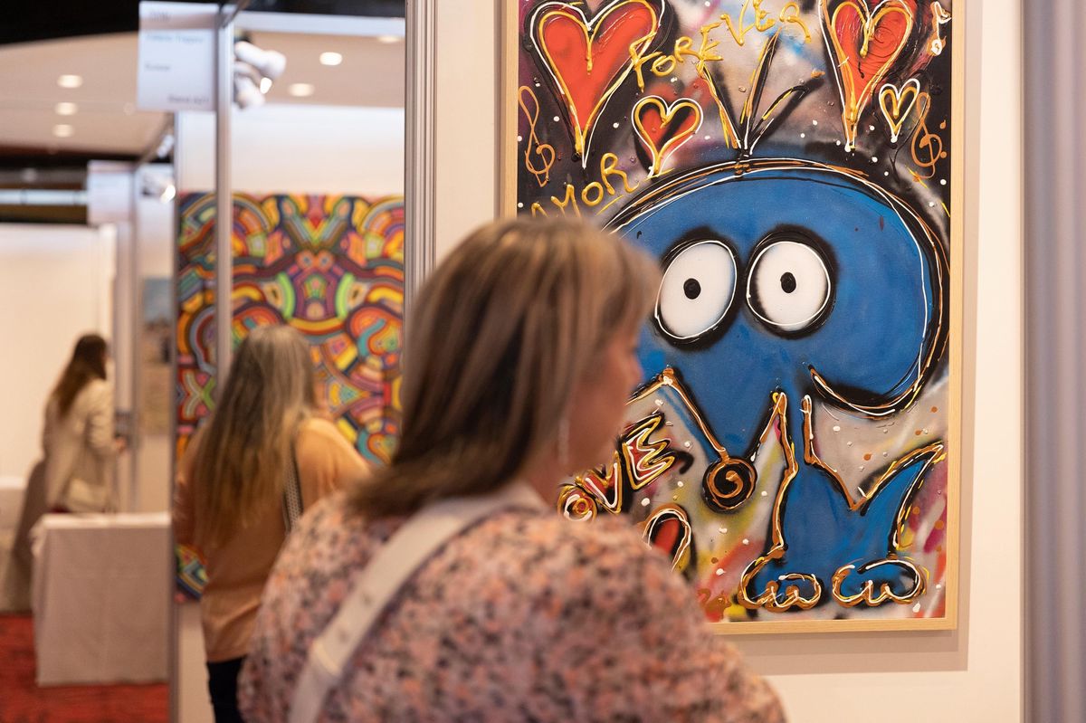 Une femme observe une œuvre colorée avec des motifs de cœur à la Montreux Art Gallery au Casino, le 7 novembre 2024.