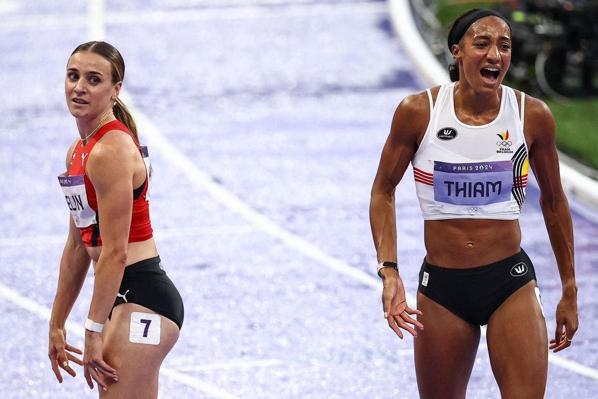 Belgium's Nafissatou Thiam reacts next to Switzerland's Annik Kaelin after the women's heptathlon 800m of the athletics event at the Paris 2024 Olympic Games at Stade de France in Saint-Denis, north of Paris, on August 9, 2024. (Photo by Anne-Christine POUJOULAT / AFP)