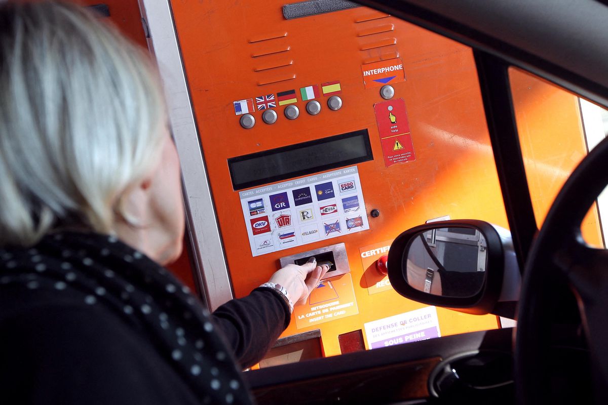 Personne payant à une borne de péage à Nice, le 1ᵉʳ février 2012, lors de l’augmentation des tarifs autoroutiers en France.