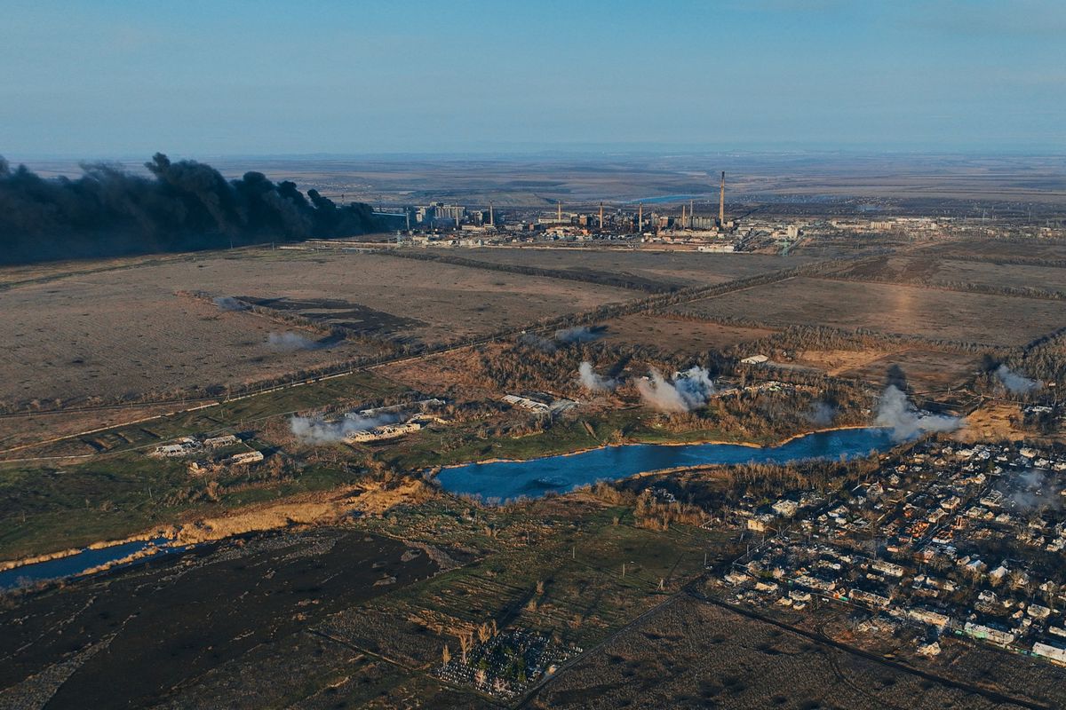 AVDIIVKA DISTRIKT, UKRAINE - FEBRUARY 15:  (EDITOR'S NOTE: No new use of feed image after March 16, 2024. After that date, image will need to be licensed from the website.) A general view of smoke rising from the Avdiivka Coke and Chemical Plant behind the village of Lastochkino, which is under fire from MLRS "Grad" on February 15, 2023 in Avdiivka district, Ukraine. The Russian army is advancing on the flanks of the city, firing non-stop artillery, shelling the city with guided aerial bombs (FAB-500). Both Ukraine and Russia have recently claimed gains in the Avdiivka, where Russia is continuing a long-running campaign to capture the city, located in the Ukraine's eastern Donetsk Region. Last week, the Russian army was successful in advancing towards the city and captured the main supply road (Photo by Kostiantyn Liberov/Libkos/Getty Images) A bird's-eye view from a drone.