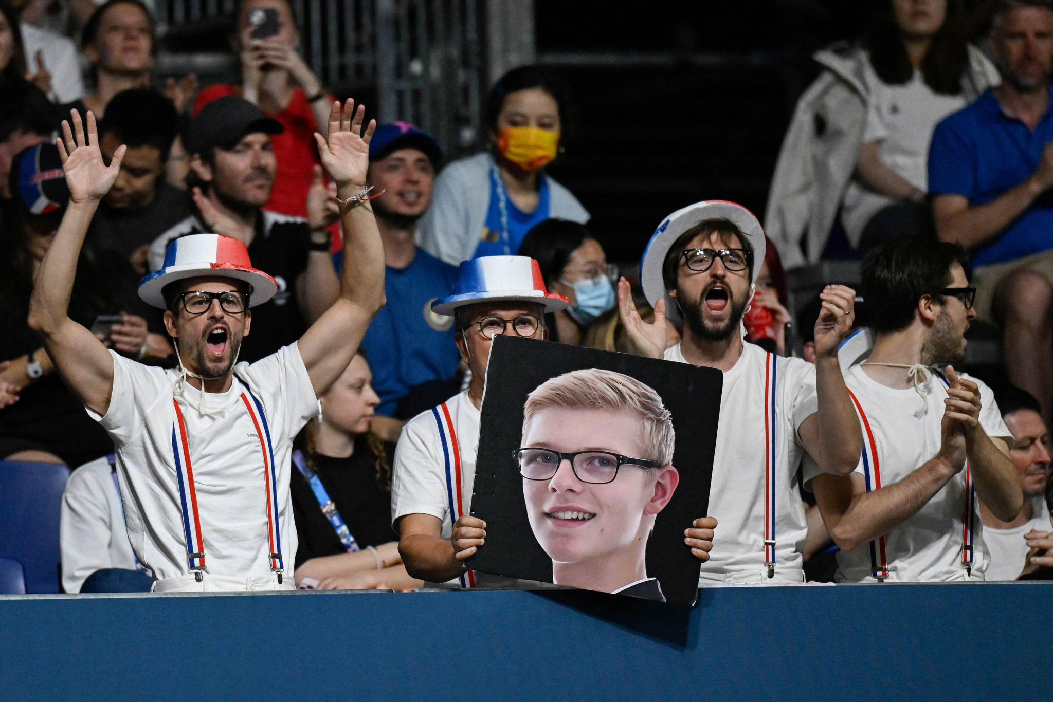 Supporters of France's Felix Lebrun holds a poster of him during his men's table tennis singles bronze medal match against Brazil's Hugo Calderano at the Paris 2024 Olympic Games at the South Paris Arena in Paris on August 4, 2024. (Photo by WANG Zhao / AFP)