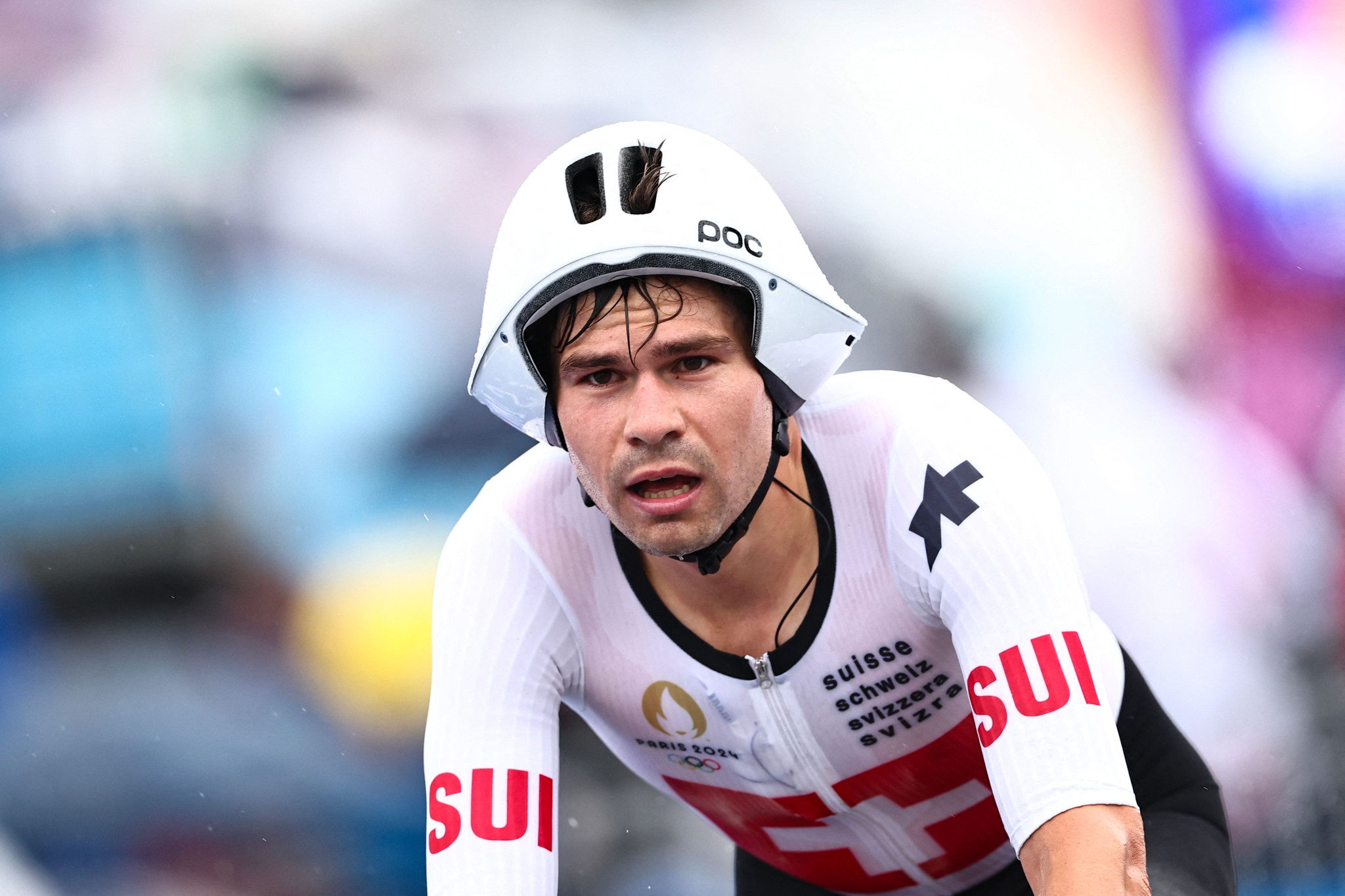 Switzerland's Stefan Bissegger cycles to cross the finish line of the men's road cycling individual time trial during the Paris 2024 Olympic Games in Paris, on July 27, 2024. (Photo by Anne-Christine POUJOULAT / AFP)