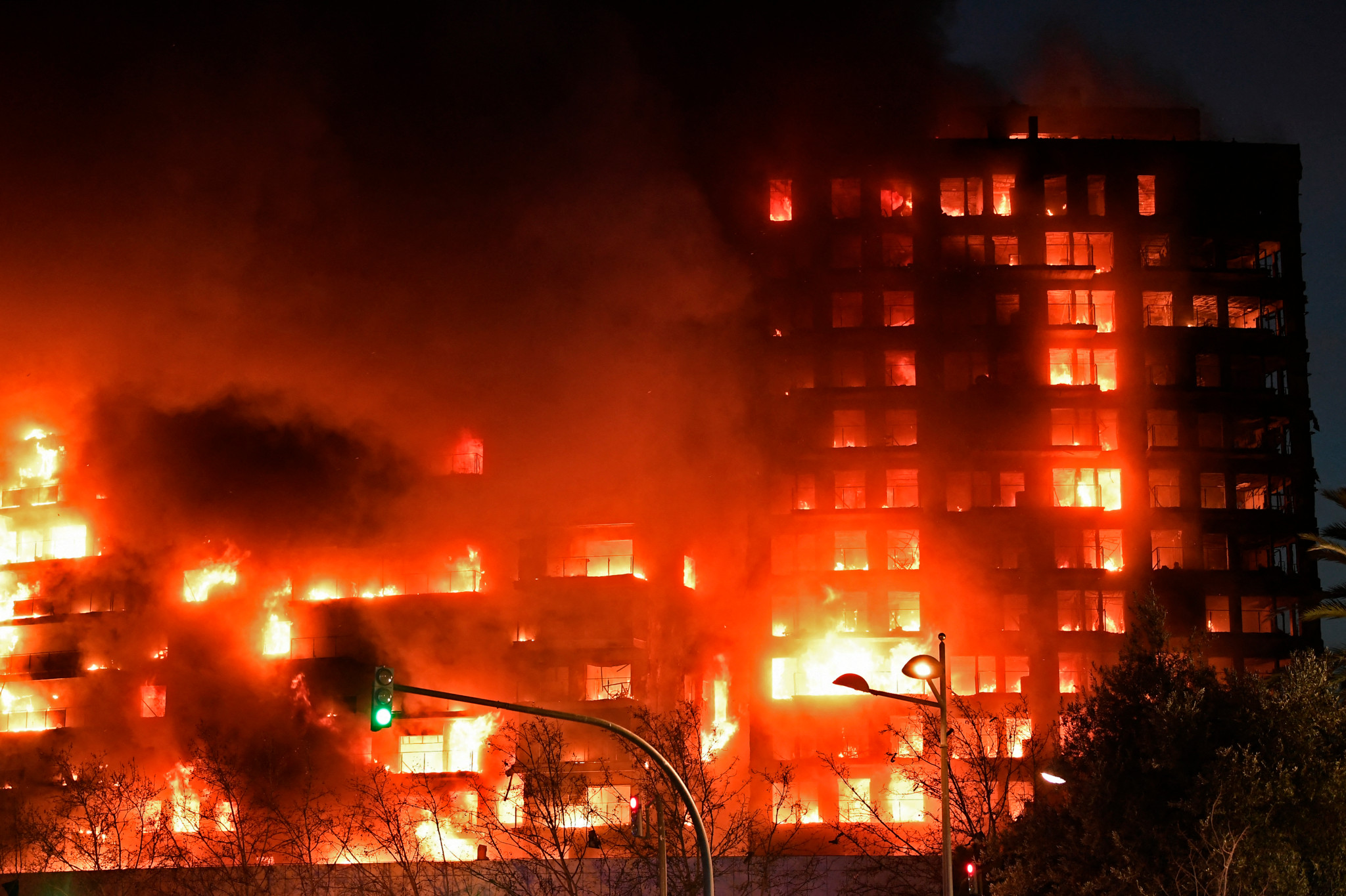 A huge fire rages through a multistorey residential block in Valencia on February 22, 2024. (Photo by Jose Jordan / AFP)