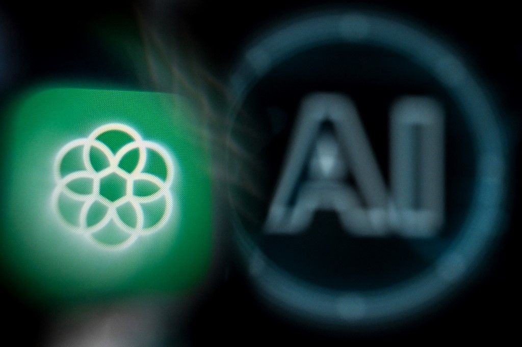 A photo taken on November 23, 2023 shows the logo of the ChatGPT application developed by US artificial intelligence research organization OpenAI on a smartphone screen (L) and the letters AI on a laptop screen in Frankfurt am Main, western Germany. Sam Altman's shock return as chief executive of OpenAI late on November 22 -- days after being sacked -- caps a chaotic period that highlighted deep tensions at the heart of the Artificial Intelligence community. The board that fired Altman from his role as CEO of the ChatGPT creator has been almost entirely replaced following a rebellion by employees, cementing his position at the helm of the firm. (Photo by Kirill KUDRYAVTSEV / AFP)