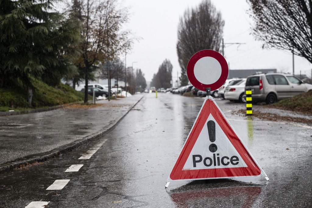 A police warning sign ahaed of a closed road after a shooting in Sion, Switzerland, Monday, December 11, 2023. According to the police of the canton of Valais. An individual fired several shots in Sion on Monday morning, at two separate locations. Two people died and another was injured. An individual fired several shots in Sion on Monday morning, at two separate locations. Two people died and another was injured. (KEYSTONE/Louis Dasselborne)