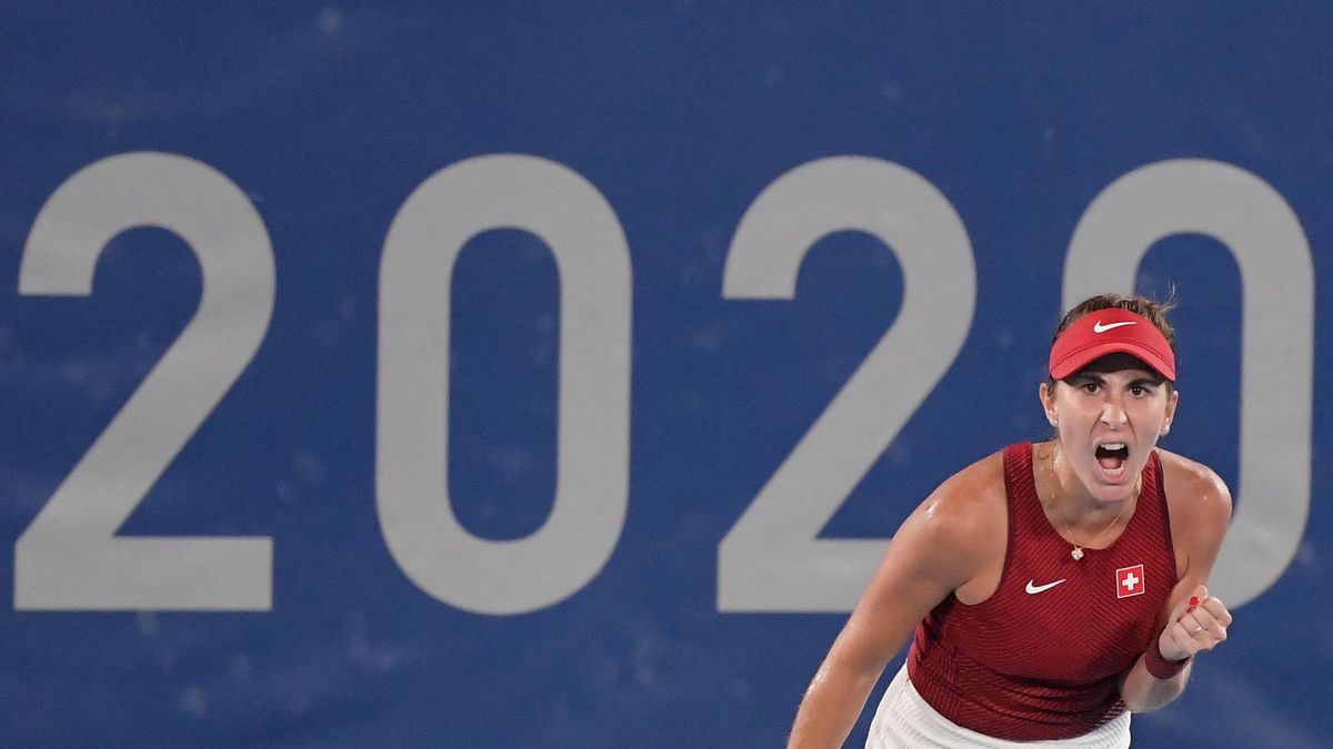Switzerland's Belinda Bencic returns the ball to Kazakhstan's Elena Rybakina during their Tokyo 2020 Olympic Games women's singles semifinal tennis match at the Ariake Tennis Park in Tokyo on July 29, 2021. (Photo by Tiziana FABI / AFP)