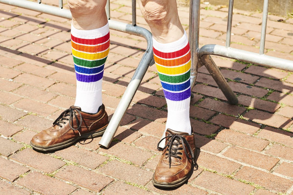 An attendee wears rainbow pride flag socks during an event for the Stonewall Inn 50th anniversary commemoration in New York, U.S., on Friday, June 28, 2019. Fifty years ago today, a riot took place at the Stonewall Inn as police raided the New York City gay bar. That story is told so often that Stonewall is enshrined as a national monument and regarded as the birthplace of the modern gay-rights movement. Photographer: Gabby Jones/Bloomberg via Getty Images