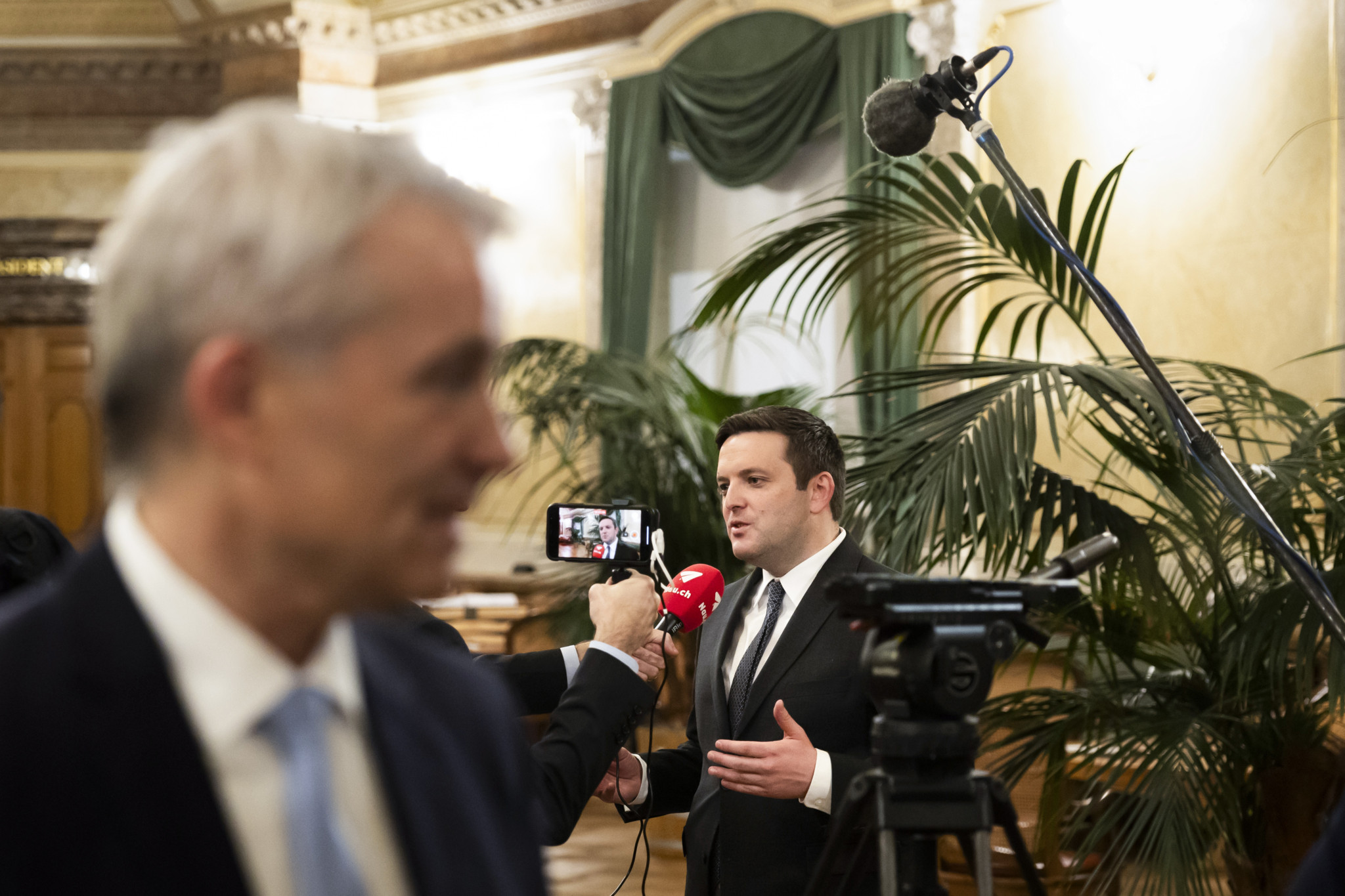 Die Bundesratskandidaten Beat Jans, Regierungspraesident Basel-Stadt, vorne, und Jon Pult, Nationalrat SP-GR, hinten, geben nach den Hearings Interviews in der Wandelhalle des Nationalrats, am Dienstag, 5. Dezember 2023 im Bundeshaus in Bern. (KEYSTONE/Peter Klaunzer)