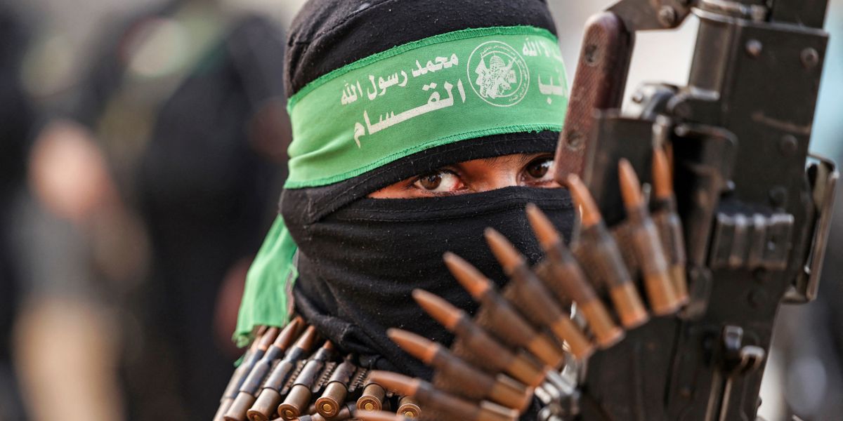 A member of Ezzedine al-Qassam Brigades, military wing of the Palestinian Hamas movement, takes part in a parade in Gaza City on November 14, 2021. (Photo by MAHMUD HAMS / AFP)