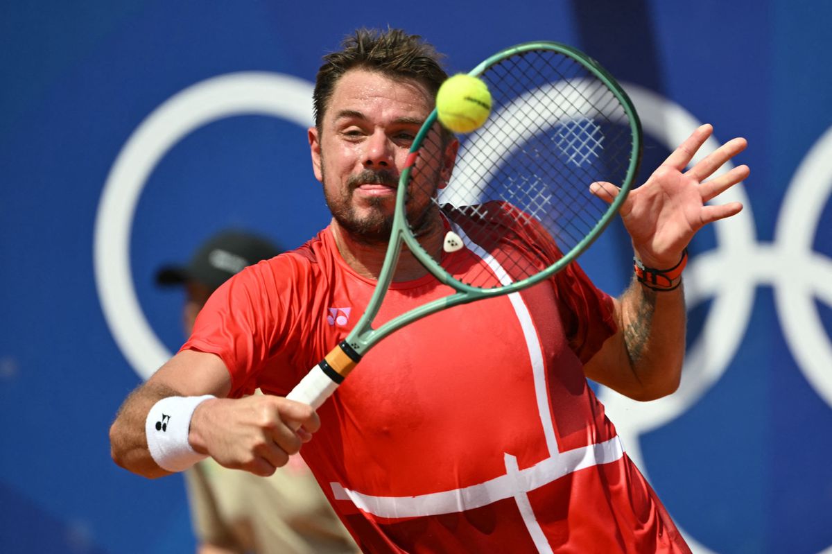 Switzerland's Stan Wawrinka returns to Australia's Alexei Popyrin during their men's singles second round tennis match at the Roland-Garros Stadium at the Paris 2024 Olympic Games, in Paris on July 30, 2024. (Photo by Miguel MEDINA / AFP)