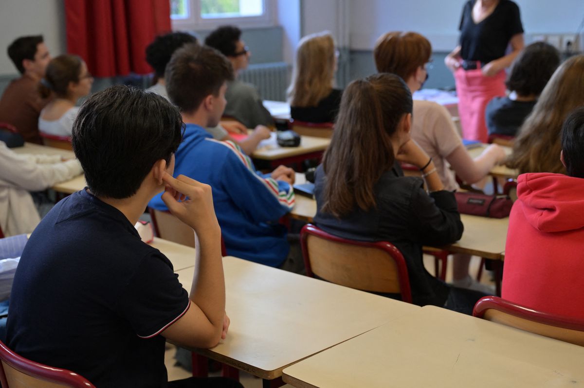 Students listen to their teacher in a classroom of Victor-Duruy high school on the first day of new academic year in Paris on September 4, 2023. Twelve million students go back to school in France on September 4, 2023. (Photo by Miguel MEDINA / AFP)
